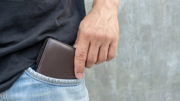 men-hold-brown-wallet-from-jeans-pocket_42546-2109